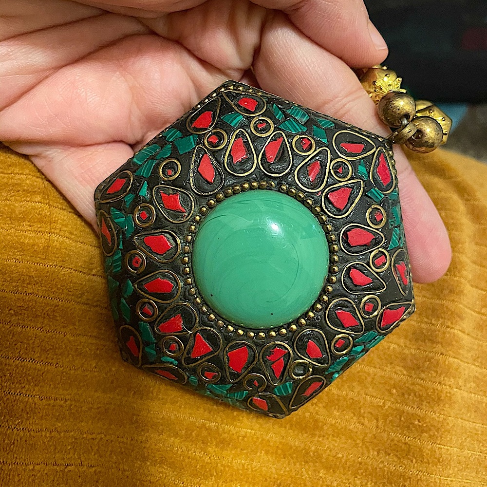 Pendant with beaded neckline